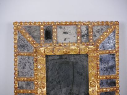 null Rectangular mirror in carved and gilded wood decorated with a frieze of pearls...