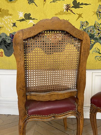 null Suite of six caned chairs in molded and carved wood decorated with flowers.

Louis...