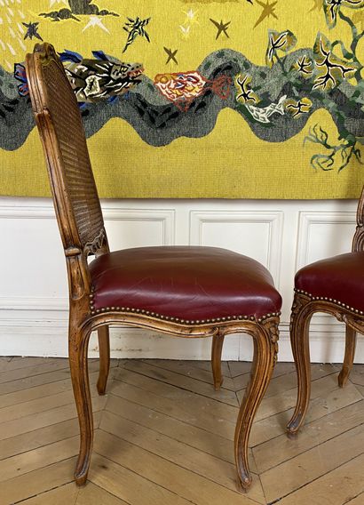 null Suite of six caned chairs in molded and carved wood decorated with flowers.

Louis...