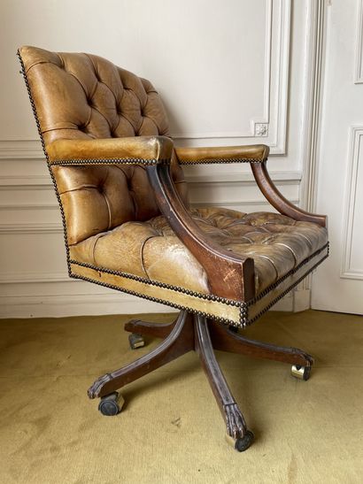 null Brown leather upholstered swivel and reclining office chair. In the Chesterfield...
