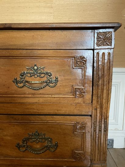 null Rectangular chest of drawers in molded and carved walnut decorated with rosettes...