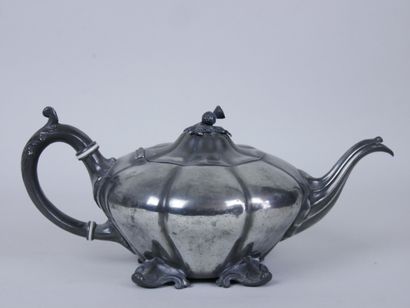 null Set of two silver plated teapots with foliage decoration, the handles resting...