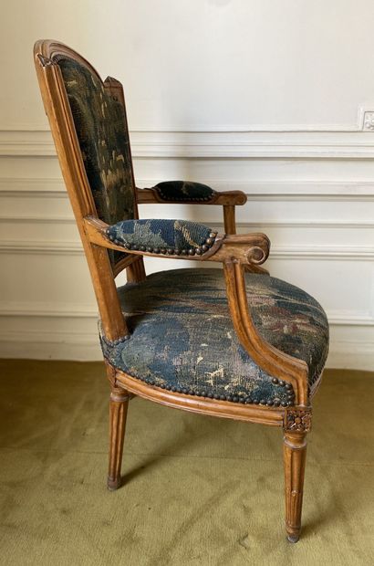 null Flat-backed armchair in carved beech with a "gendarme hat" backrest, the armrests...