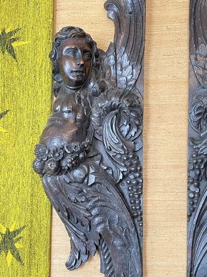 null Two jambs forming a pendant in carved and stained oak decorated with cherubs...