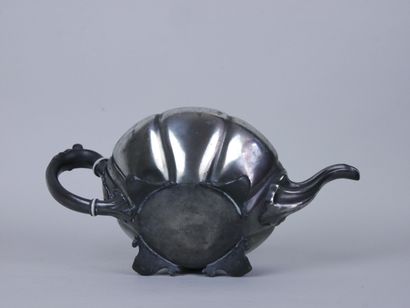 null Set of two silver plated teapots with foliage decoration, the handles resting...