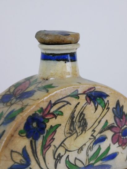 null Two cracked ceramic bottles of rectangular form for the one and rounded for...