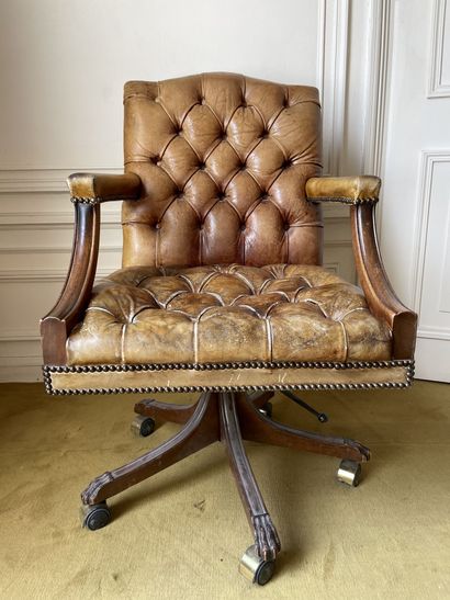 null Brown leather upholstered swivel and reclining office chair. In the Chesterfield...