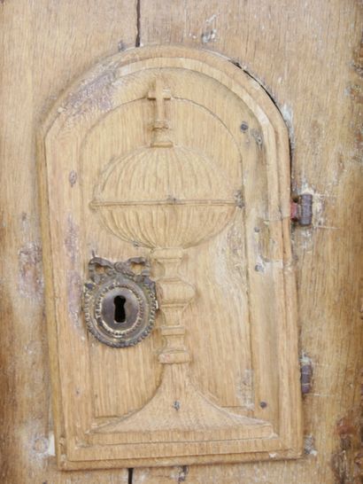 null Front of tabernacle in carved oak opening with an arched door decorated with...