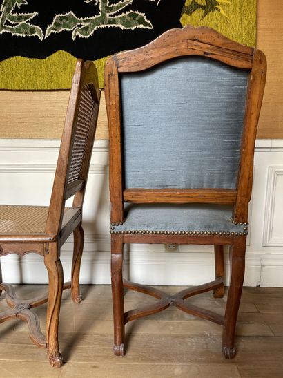 null Set of two caned chairs in molded and carved wood, the cambered legs joined...
