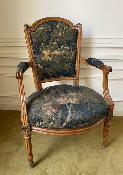 null Flat-backed armchair in carved beech with a "gendarme hat" backrest, the armrests...
