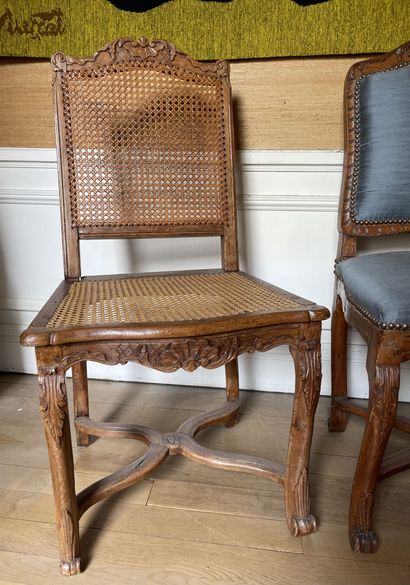 null Set of two caned chairs in molded and carved wood, the cambered legs joined...