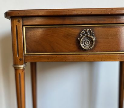 null Bedside table in cherry wood opening to a drawer in belt resting on fluted feet...