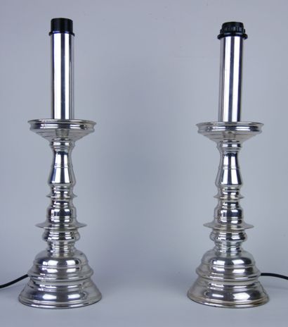 null Pair of silver plated metal torches resting on a circular base. Mounted in lamps....
