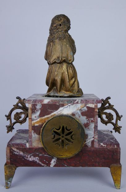 null Mantel clock in red veined marble surmounted by a praying child in gilded metal....