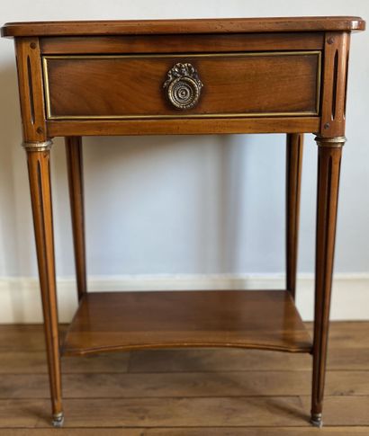 null Bedside table in cherry wood opening to a drawer in belt resting on fluted feet...