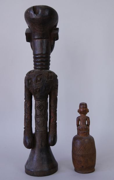 null AFRICA 

Two sculptures in carved and stained wood representing a man standing...