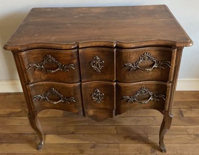 null Walnut chest of drawers opening to two drawers in front of a crossbow, resting...
