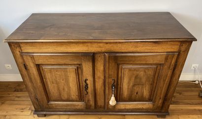 null Carved natural wood cabinet opening to two doors with molded panels, resting...