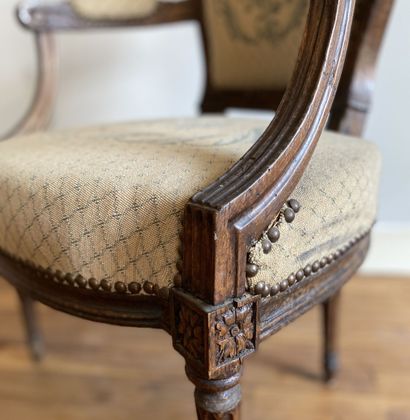 null Armchair with medallion back in molded wood, the brackets of armrests in whips,...