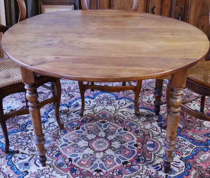 null Round dining room table in natural wood, with two flaps, resting on 4 turned...