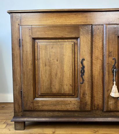 null Carved natural wood cabinet opening to two doors with molded panels, resting...