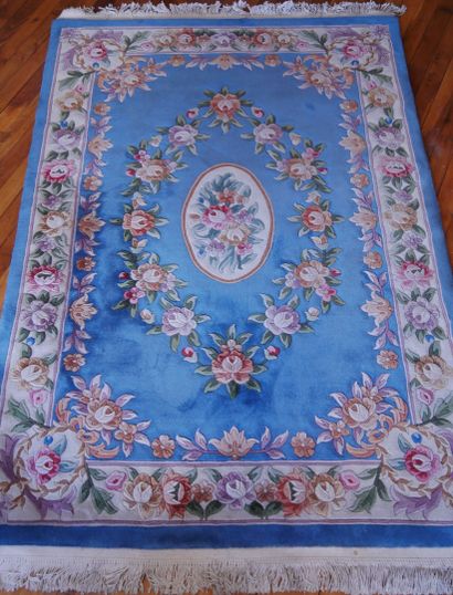 Wool carpet with a wide border of roses on...