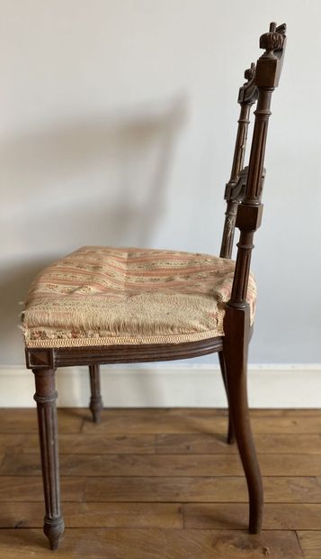 null Pair of carved wood chairs with a barred backrest topped by a ribboned bow resting...