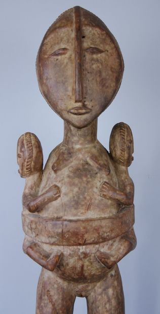 null AFRICA 

Wooden maternity sculpture representing a woman carrying twins on either...