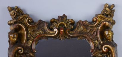 null Carved and gilded wood mirror decorated with scrolls, shells, fire pots, palmettes...
