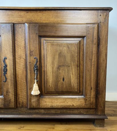 null Carved natural wood cabinet opening to two doors with molded panels, resting...