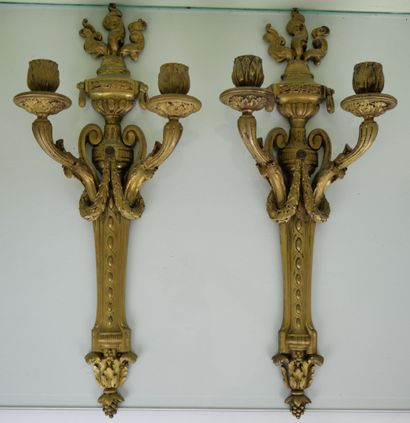 null Pair of two-light sconces in chased and gilded bonze decorated with a flaming...
