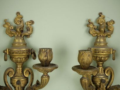 null Pair of two-light sconces in chased and gilded bonze decorated with a flaming...
