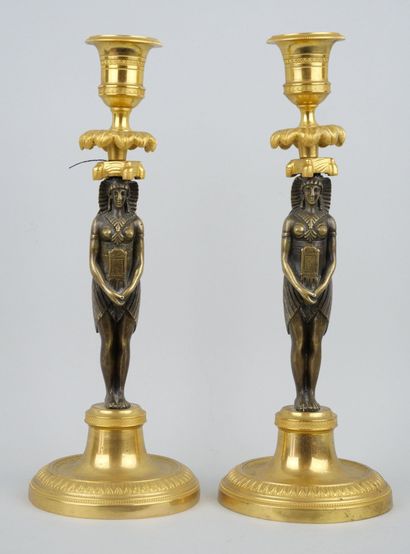 null Pair of ormolu and bronze torches with olive green patina, the shafts in the...