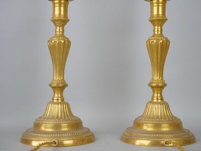 null Pair of gilt bronze torches.

Louis XVI style, 19th century.

(Drilled for electricity,...