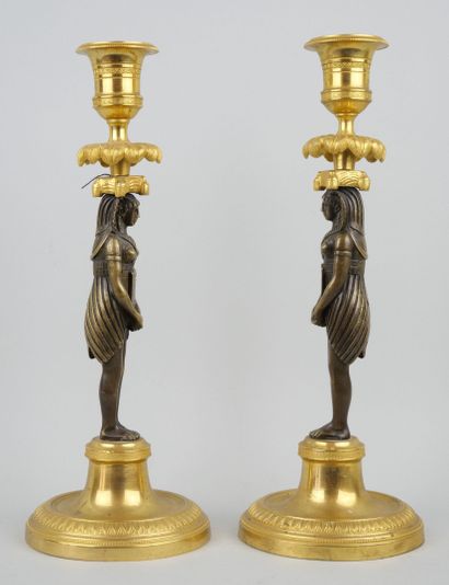 null Pair of ormolu and bronze torches with olive green patina, the shafts in the...