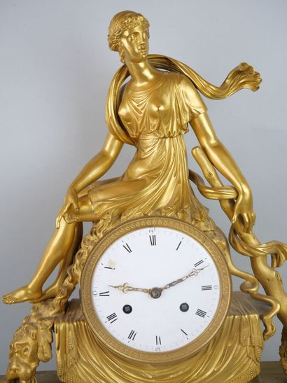 null Gilded bronze clock, representing Omphale sitting on the movement, accompanied...