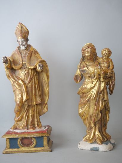 null Two statuettes in carved wood and partially gilded including : 

A Virgin and...