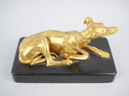 null Paperweight in gilt bronze representing a greyhound lying down. Black marble...