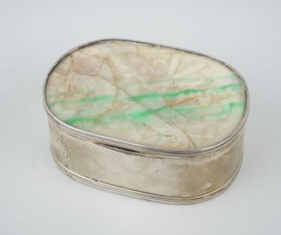 null Oval silver box, the lid set with a jadeite plate decorated with everyday objects.

China...