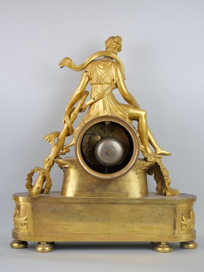 null Gilded bronze clock, representing Omphale sitting on the movement, accompanied...