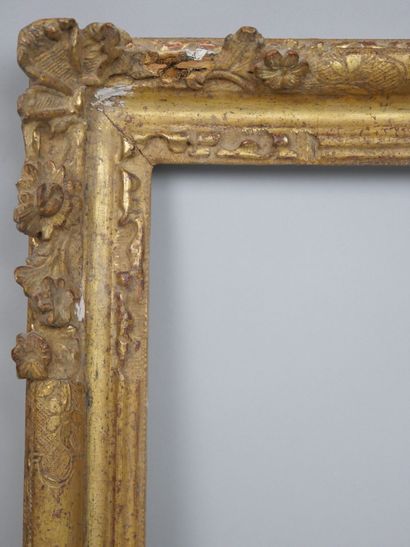 null Small carved and gilded wood frame with openwork decoration of shells and flowers....
