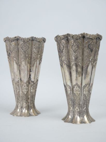 null Pair of metal horn vases of poly-lobed form with chased decoration of flowers....