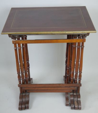 null Suite of four mahogany veneered and brass filleted nesting tables.

End of the...