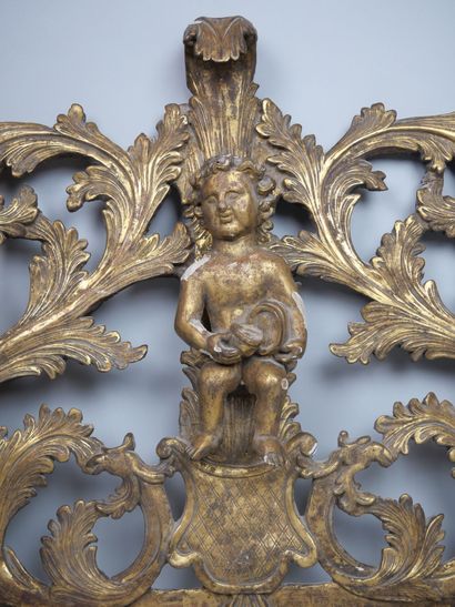 null Fronton of a mirror in carved and gilded wood, decorated with young Bacchus...