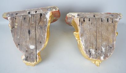 null Pair of carved and gilded wood sconces, the tops painted in trompe-l'oeil.

Eighteenth...