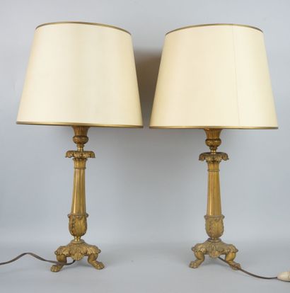 A pair of ormolu torches resting on a tripod...