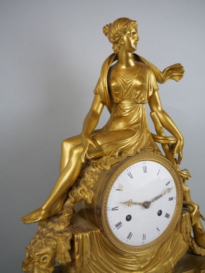 null Gilded bronze clock, representing Omphale sitting on the movement, accompanied...
