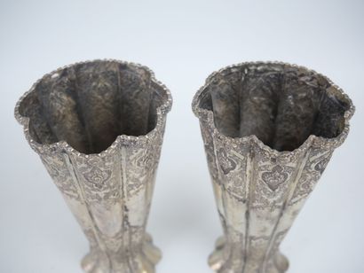 null Pair of metal horn vases of poly-lobed form with chased decoration of flowers....