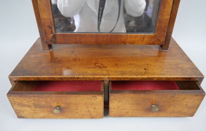null Mirror toilet in mahogany veneer resting on a box containing two drawers. The...