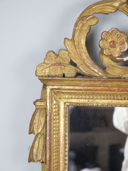 null A molded wood pediment mirror of rectangular shape, carved and gilded with a...
